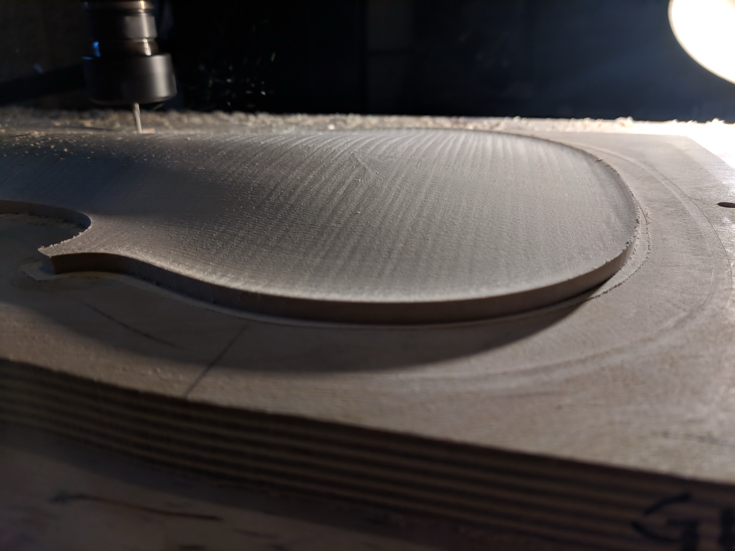 Milled spruce and maple violin tonewood plates alongside moulds